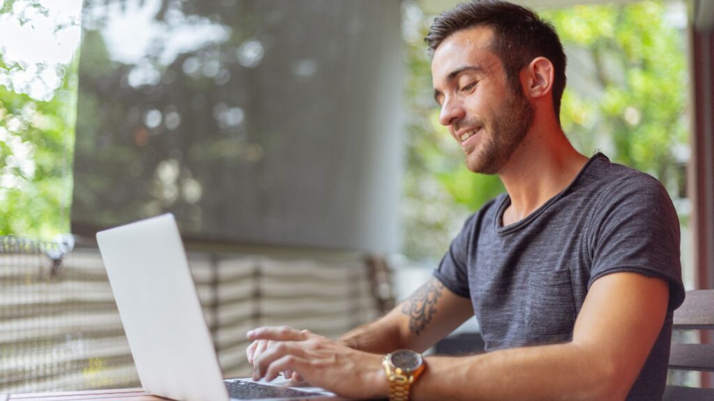 man looking online for gun accessories